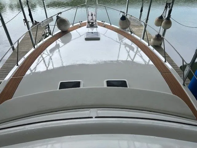  Yacht Photos Pics 1984 Post 43 Sport Fisherman boat deck with wooden trim and docked at a marina.