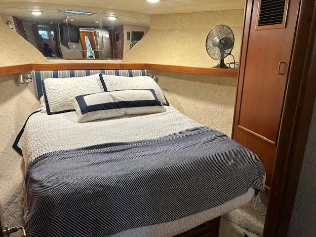  Yacht Photos Pics Cozy cabin interior of 1984 Post 43 Sport Fisherman with bed and fan.