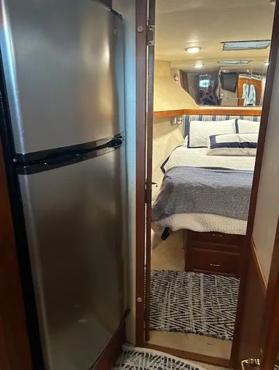  Yacht Photos Pics Interior of 1984 Post 43 Sport Fisherman with bed and stainless steel fridge.