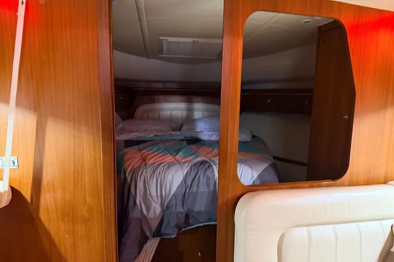  Yacht Photos Pics 2004 Tiara Yachts 3600 Sovran cabin interior with bed and wooden paneling.