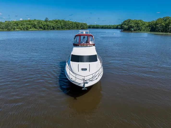 Lil Peace Yacht Photos Pics 2005 Sea Ray 420 Sedan Bridge on a calm river.