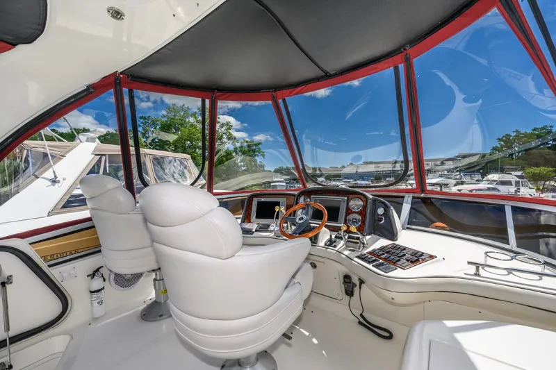 Lil Peace Yacht Photos Pics 2005 Sea Ray 420 Sedan Bridge helm with dual captain chairs and panoramic view.