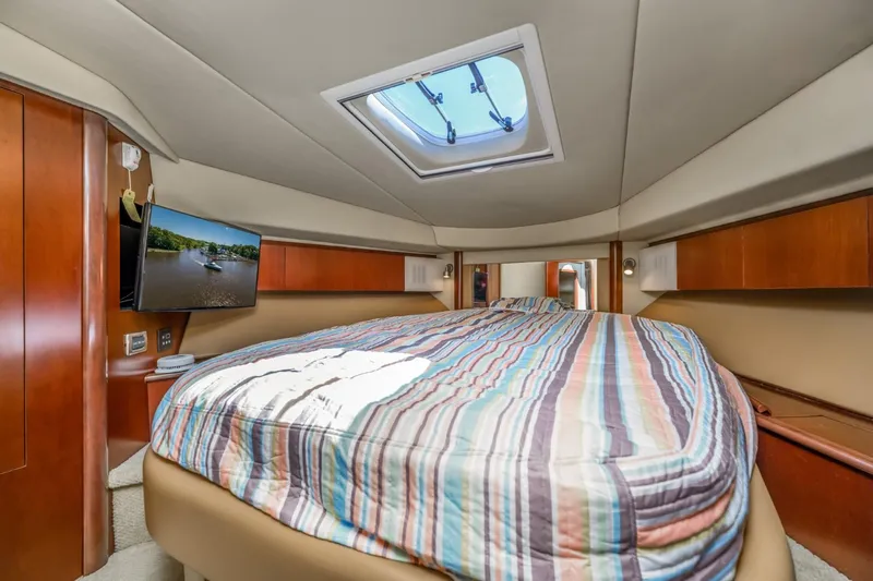 Lil Peace Yacht Photos Pics Luxurious bedroom interior of 2005 Sea Ray 420 Sedan Bridge yacht with skylight and TV.