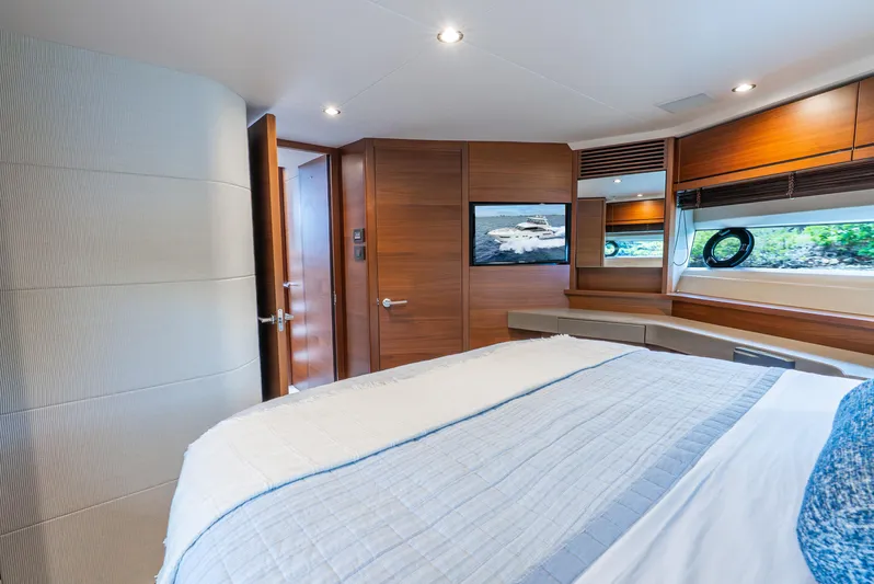 Mamu Yacht Photos Pics Luxurious bedroom interior of 2018 Princess F-68 yacht with modern wood paneling.