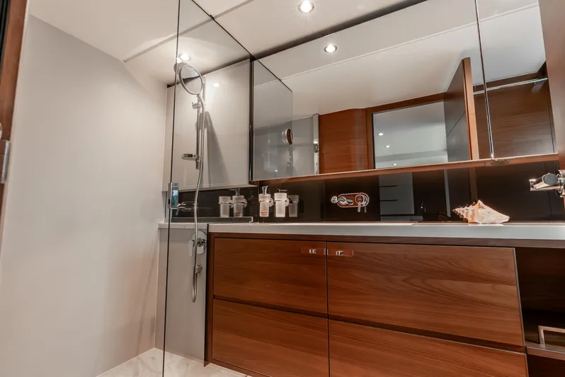 Mamu Yacht Photos Pics Luxurious bathroom interior on 2018 Princess F-68 yacht with modern wood cabinetry and sleek fixtures.