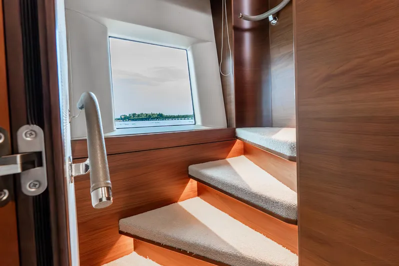 Mamu Yacht Photos Pics Luxurious interior staircase of 2018 Princess F-68 yacht with scenic window view.