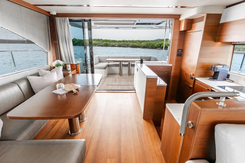 Mamu Yacht Photos Pics Luxurious interior of 2018 Princess F-68 yacht with elegant wood finishes and scenic water view.