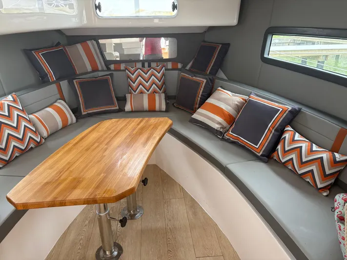  Yacht Photos Pics Luxurious Hanover 377 yacht interior with stylish cushions and wooden table, 2023 model.