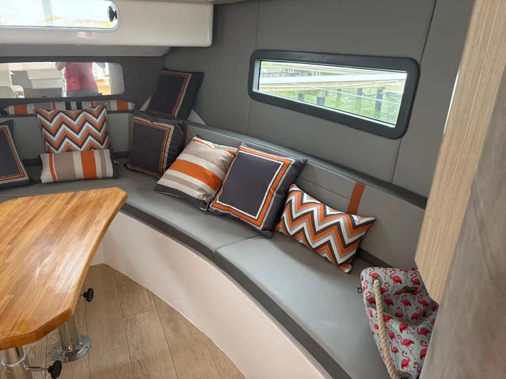  Yacht Photos Pics Luxurious Hanover 377 yacht interior with stylish cushions and wooden table, 2023 model.
