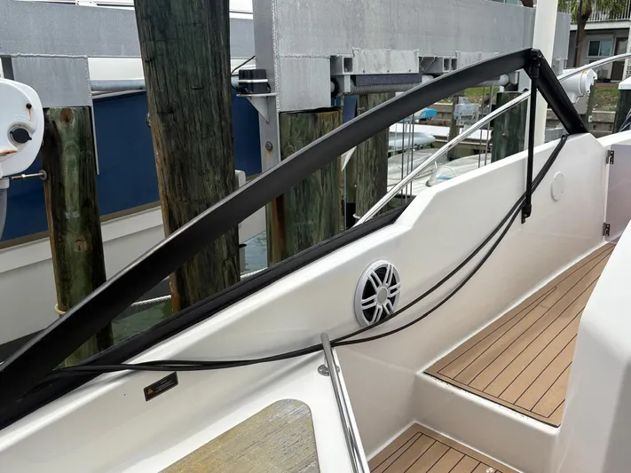  Yacht Photos Pics 2023 Hanover 377 boat deck with wooden flooring and sleek railing design.
