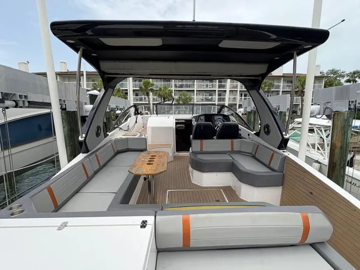  Yacht Photos Pics Luxurious 2023 Hanover 377 boat with spacious seating and sleek design at a marina.