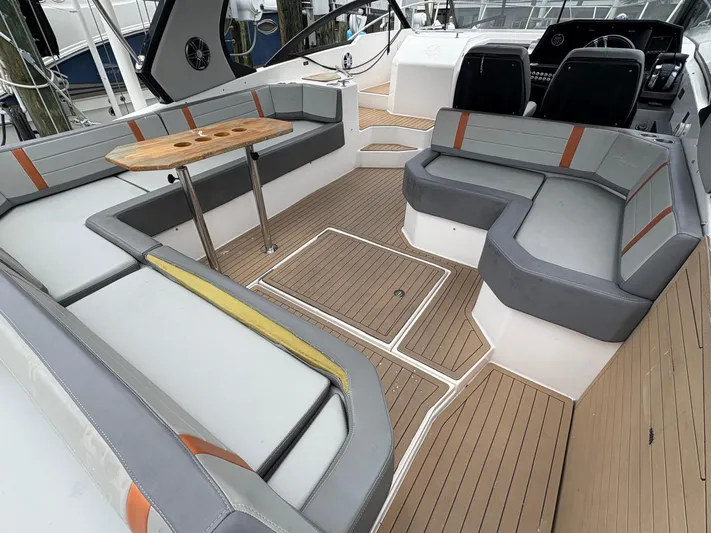  Yacht Photos Pics Spacious seating area on 2023 Hanover 377 boat with modern design and wooden accents.