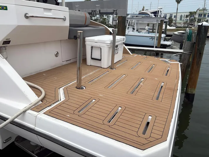  Yacht Photos Pics 2023 Hanover 377 boat deck with teak flooring at a marina.