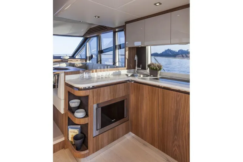 Marine Services S.a.s. Di Berruto Claudia Yacht Photos Pics Luxurious kitchen interior of 2015 Absolute 45 FLY yacht with wood finish and ocean view.