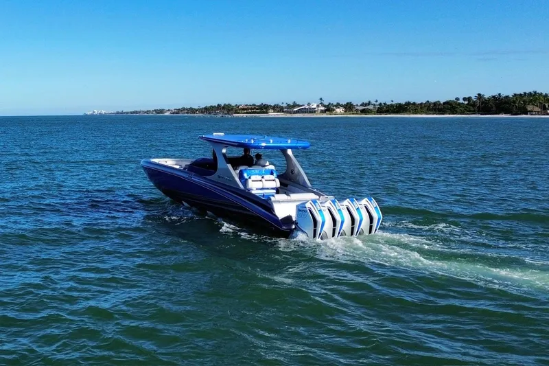 Take It To The Max Yacht Photos Pics 2023 Mystic Powerboats M3800 cruising on open water, showcasing sleek design and powerful engines.