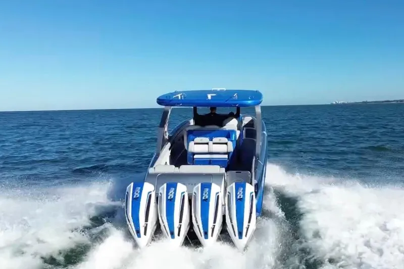 Take It To The Max Yacht Photos Pics 2023 Mystic Powerboats M3800 cruising on open water, showcasing powerful engines.