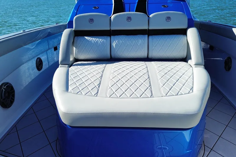 Take It To The Max Yacht Photos Pics 2023 Mystic Powerboats M3800 interior with luxurious quilted seating on a sunny day.