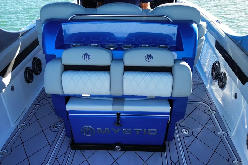Take It To The Max Yacht Photos Pics 2023 Mystic Powerboats M3800 interior with blue and white seating and cup holders.