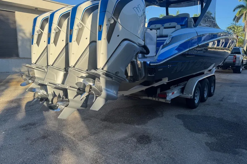 Take It To The Max Yacht Photos Pics 2023 Mystic Powerboats M3800 with quad engines on a trailer, showcasing sleek design.