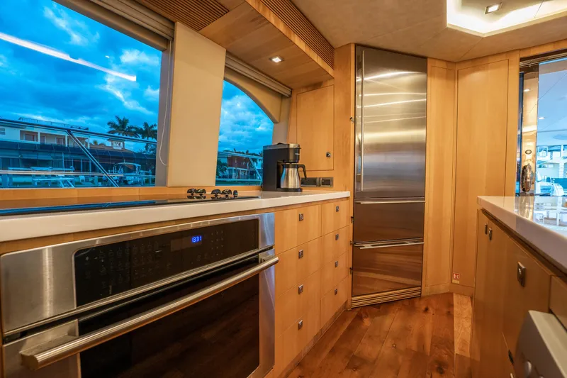 Tranquility Yacht Photos Pics Luxurious kitchen interior of 2013 Horizon PC60 yacht with modern appliances and scenic window view.