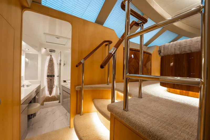 Tranquility Yacht Photos Pics Luxurious interior of 2013 Horizon PC60 yacht with elegant staircase and modern bathroom.