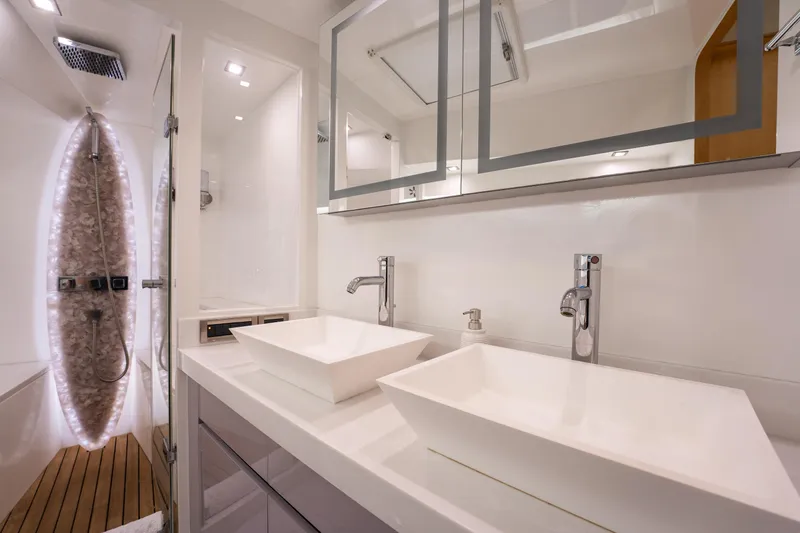 Tranquility Yacht Photos Pics Luxurious bathroom in 2013 Horizon PC60 yacht with dual sinks and modern shower.