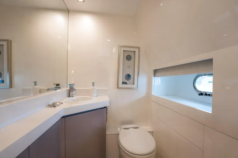 Tranquility Yacht Photos Pics Luxurious bathroom in 2013 Horizon PC60 yacht with modern fixtures and porthole window.
