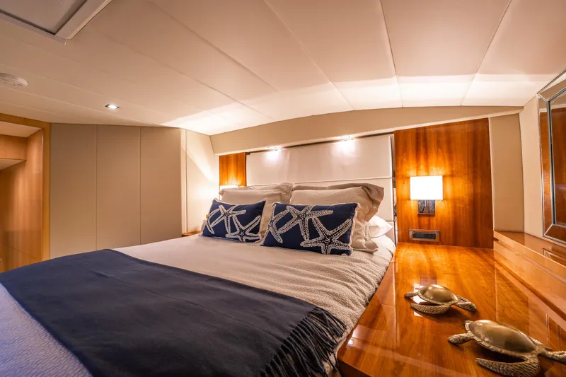 Tranquility Yacht Photos Pics Luxurious bedroom interior of 2013 Horizon PC60 yacht with elegant decor and starfish pillows.