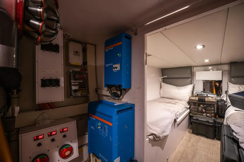 Tranquility Yacht Photos Pics Interior of a 2013 Horizon PC60 yacht with electrical panels and cozy sleeping quarters.