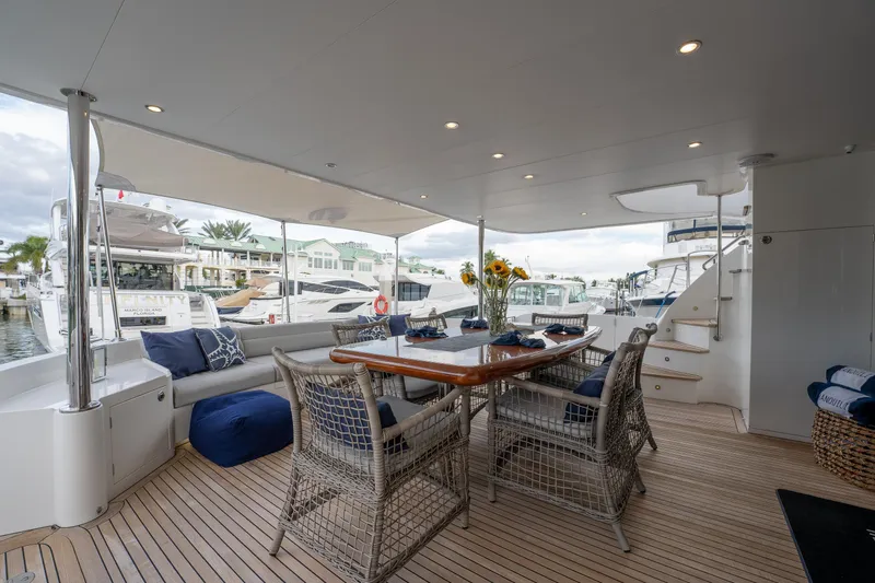 Tranquility Yacht Photos Pics Luxurious 2013 Horizon PC60 yacht deck with elegant dining area and marina view.
