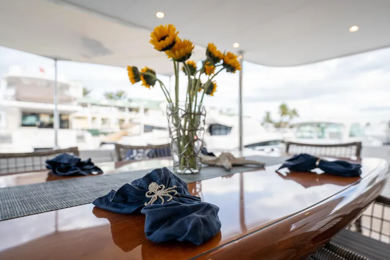 Tranquility Yacht Photos Pics Elegant yacht dining setup with sunflowers on Horizon PC60, 2013 model.