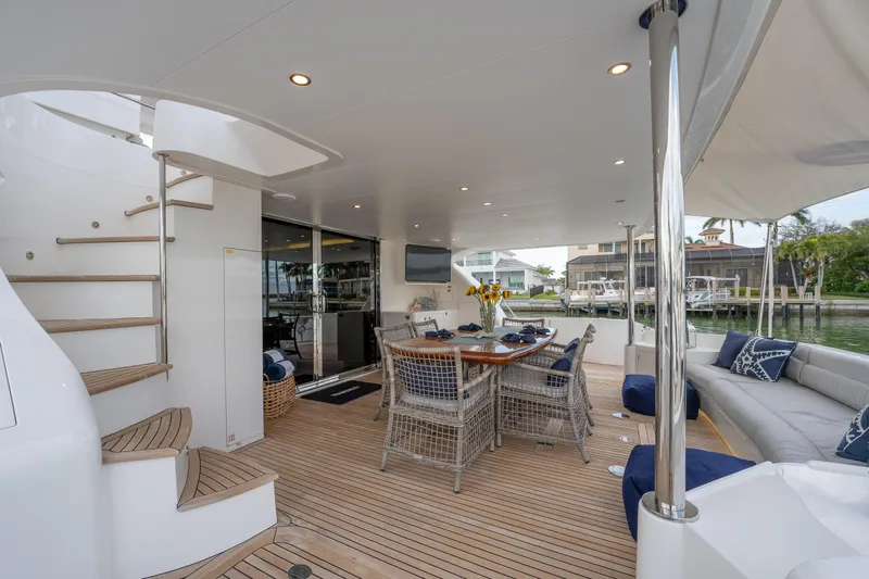 Tranquility Yacht Photos Pics Luxurious 2013 Horizon PC60 yacht deck with elegant seating and dining area.