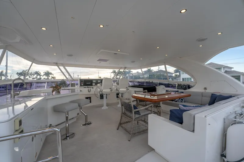 Tranquility Yacht Photos Pics Luxurious 2013 Horizon PC60 yacht interior with seating, dining area, and helm station.