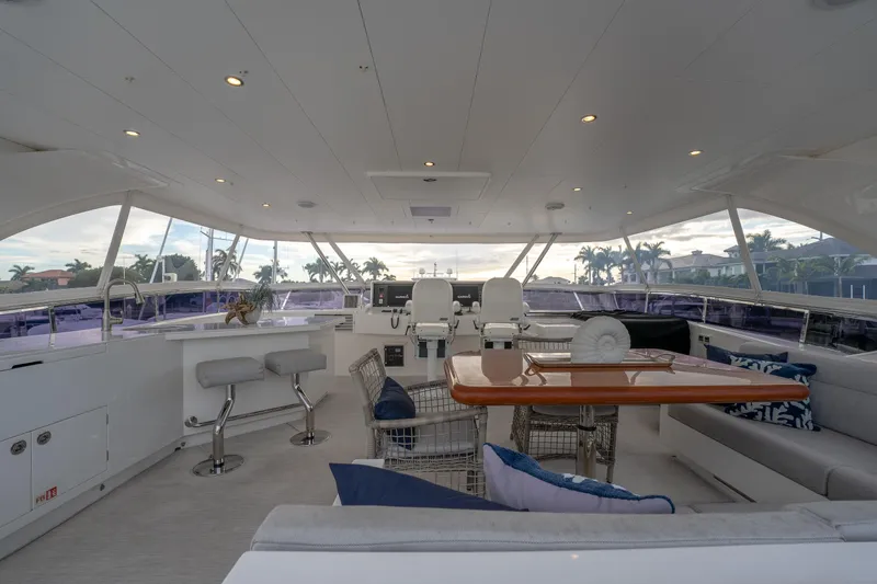 Tranquility Yacht Photos Pics Luxurious 2013 Horizon PC60 yacht interior with seating, table, and helm station.