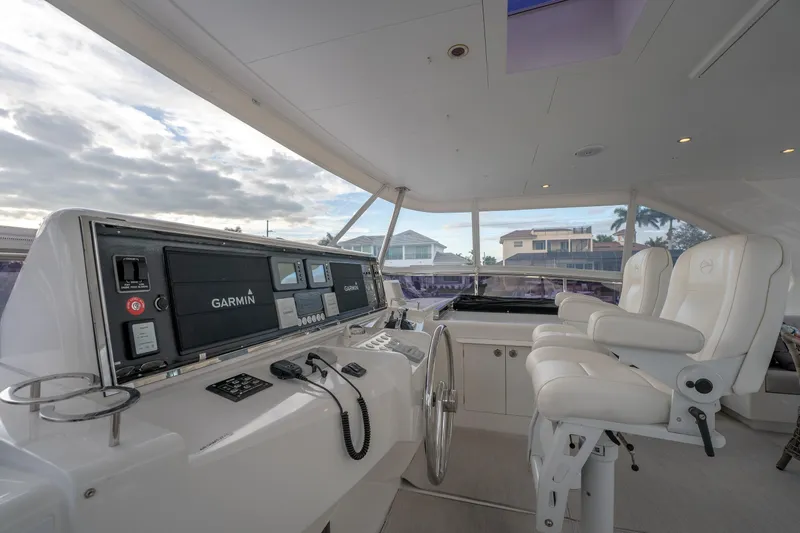 Tranquility Yacht Photos Pics Helm of 2013 Horizon PC60 yacht with Garmin navigation system and luxurious seating.