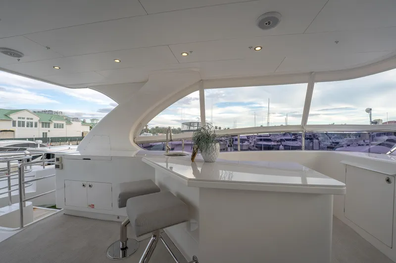 Tranquility Yacht Photos Pics Luxurious Horizon PC60 yacht interior with sleek bar area, modern seating, and marina view.