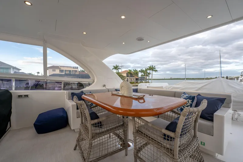 Tranquility Yacht Photos Pics Luxurious 2013 Horizon PC60 yacht deck with elegant seating and ocean view.