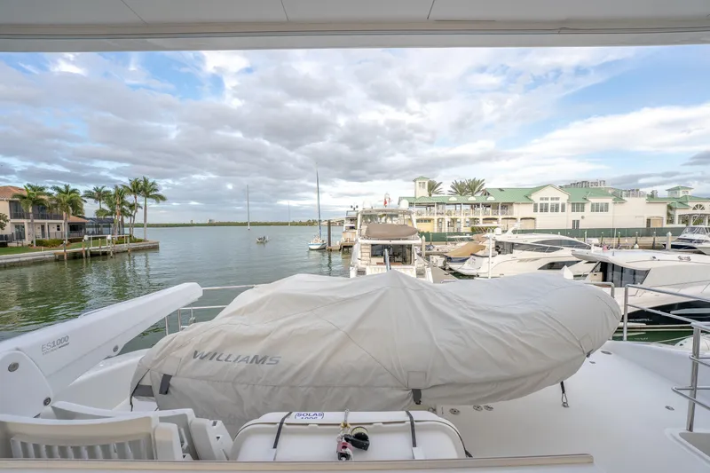 Tranquility Yacht Photos Pics Luxury Horizon PC60 yacht docked at marina, featuring covered tender, 2013 model.