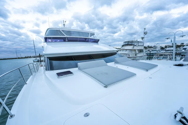 Tranquility Yacht Photos Pics Luxury Horizon PC60 yacht, 2013 model, docked at marina under cloudy sky.