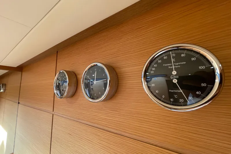  Yacht Photos Pics Wall-mounted gauges on 2013 Pershing 62 yacht, featuring clock and thermometer.