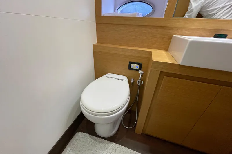  Yacht Photos Pics Luxury bathroom in 2013 Pershing 62 yacht with modern fixtures and wooden cabinetry.