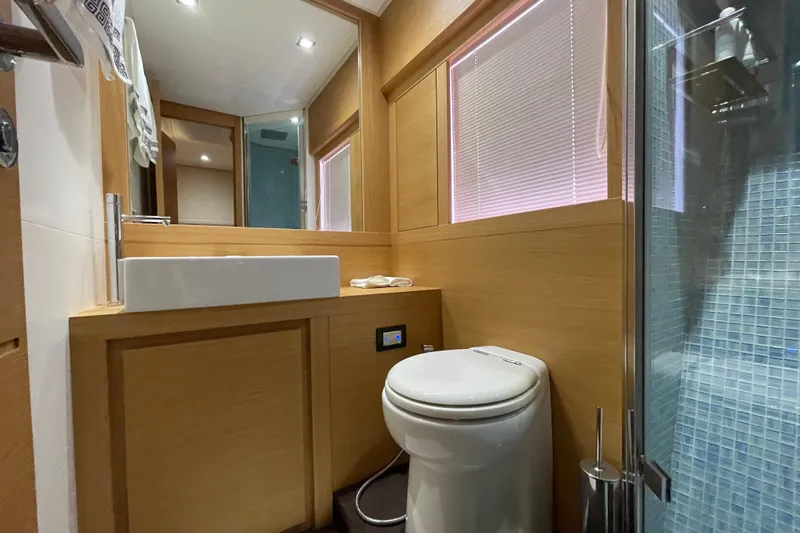  Yacht Photos Pics Luxurious bathroom interior of 2013 Pershing 62 yacht with modern fixtures and wooden accents.