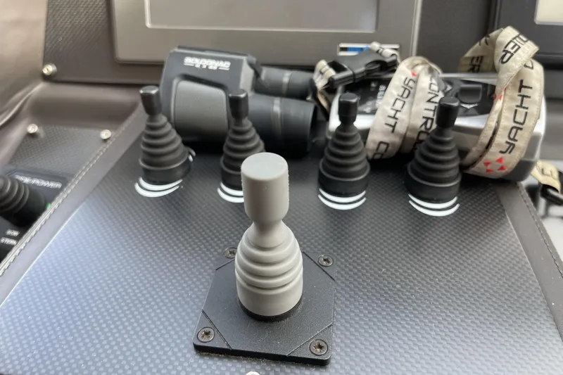  Yacht Photos Pics Control panel of a 2013 Pershing 62 yacht with joysticks and binoculars.
