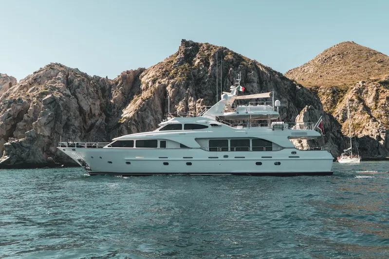 Marques Yacht Photos Pics 2008 Benetti Tradition 100 luxury yacht near rocky coastline.