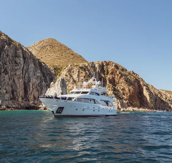 Marques Yacht Photos Pics 2008 Benetti Tradition 100 yacht near rocky coastline.