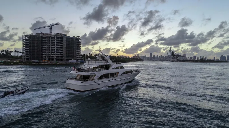 Marques Yacht Photos Pics 2008 Benetti Tradition 100 yacht cruising at sunset near city skyline.