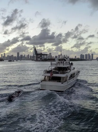 Marques Yacht Photos Pics 2008 Benetti Tradition 100 yacht cruising at sunset near city skyline.