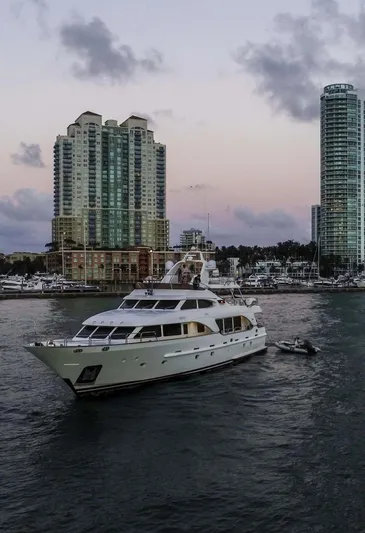 Marques Yacht Photos Pics 2008 Benetti Tradition 100 yacht cruising near city skyline.