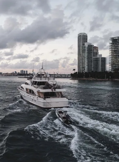 Marques Yacht Photos Pics 2008 Benetti Tradition 100 yacht cruising near modern skyline.