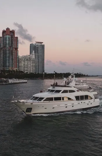 Marques Yacht Photos Pics 2008 Benetti Tradition 100 yacht cruising near city skyline.